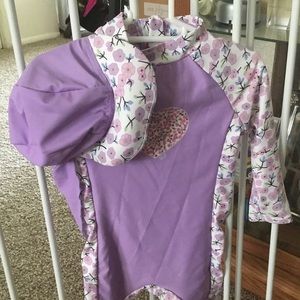 A one pice swimsuit with a hat.